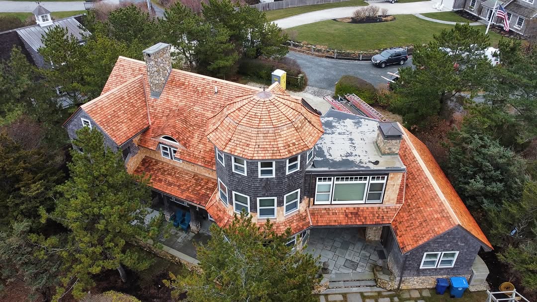 Red cedar roof with barrel windows and copper accents in North Falmouth