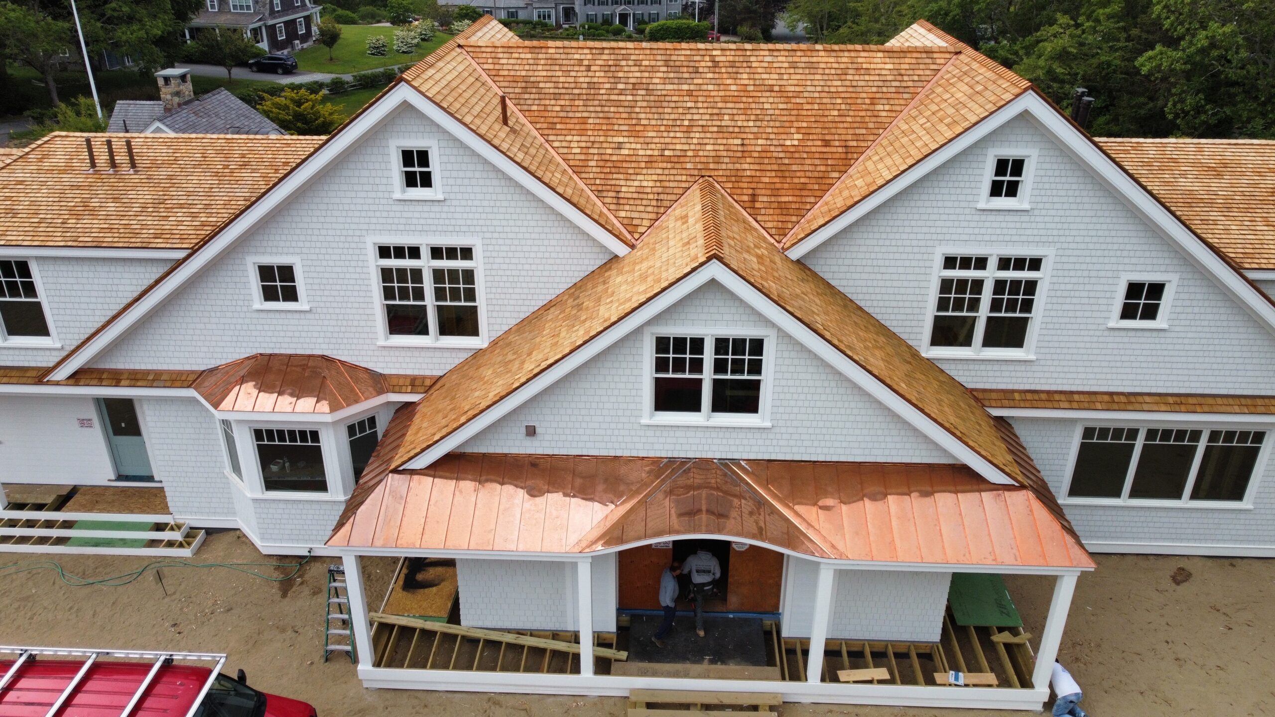 New copper roofing installation showing bright golden-pink metallic finish Cape Cod