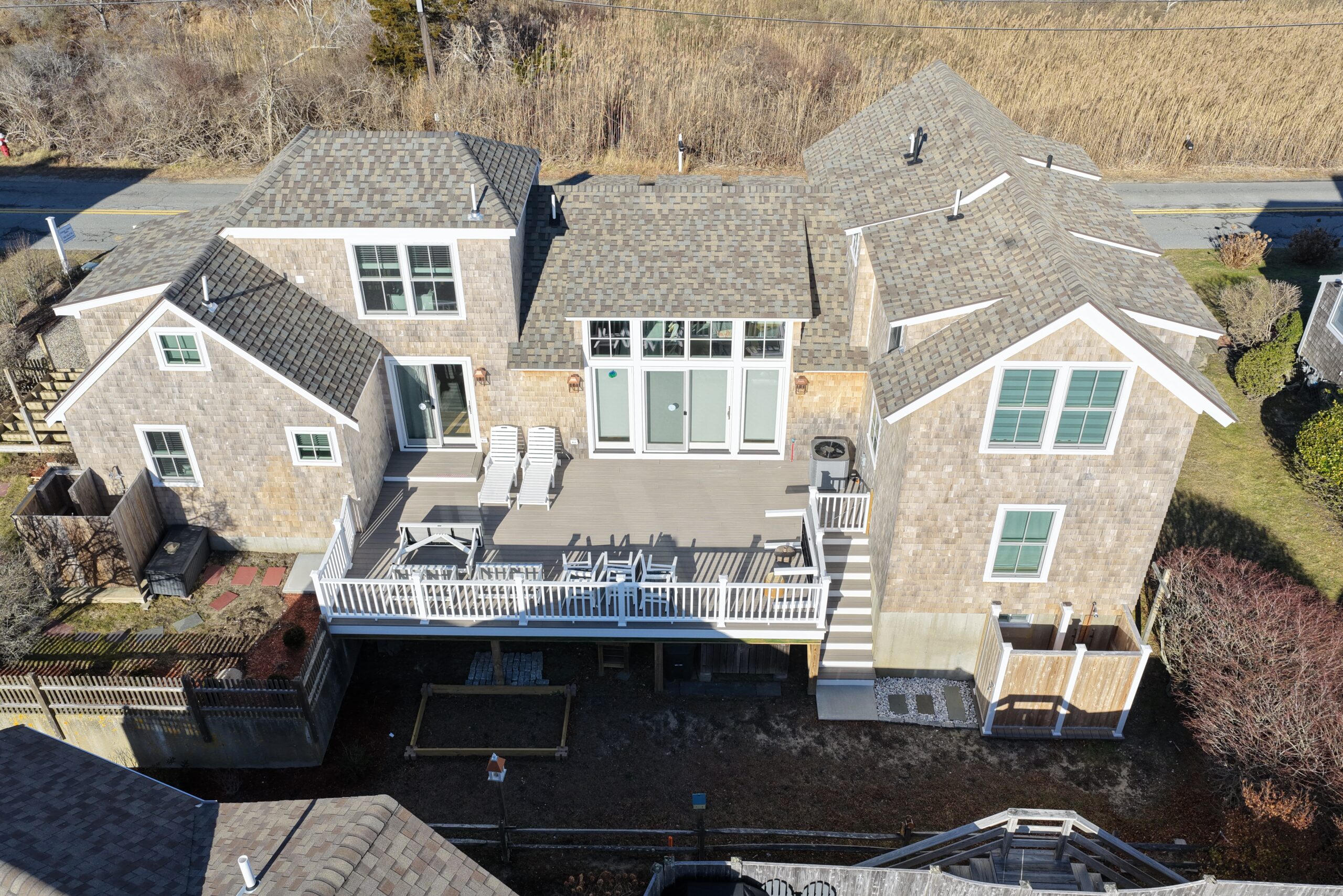 Aerial view of Chatham home with new asphalt shingle roof and natural cedar siding