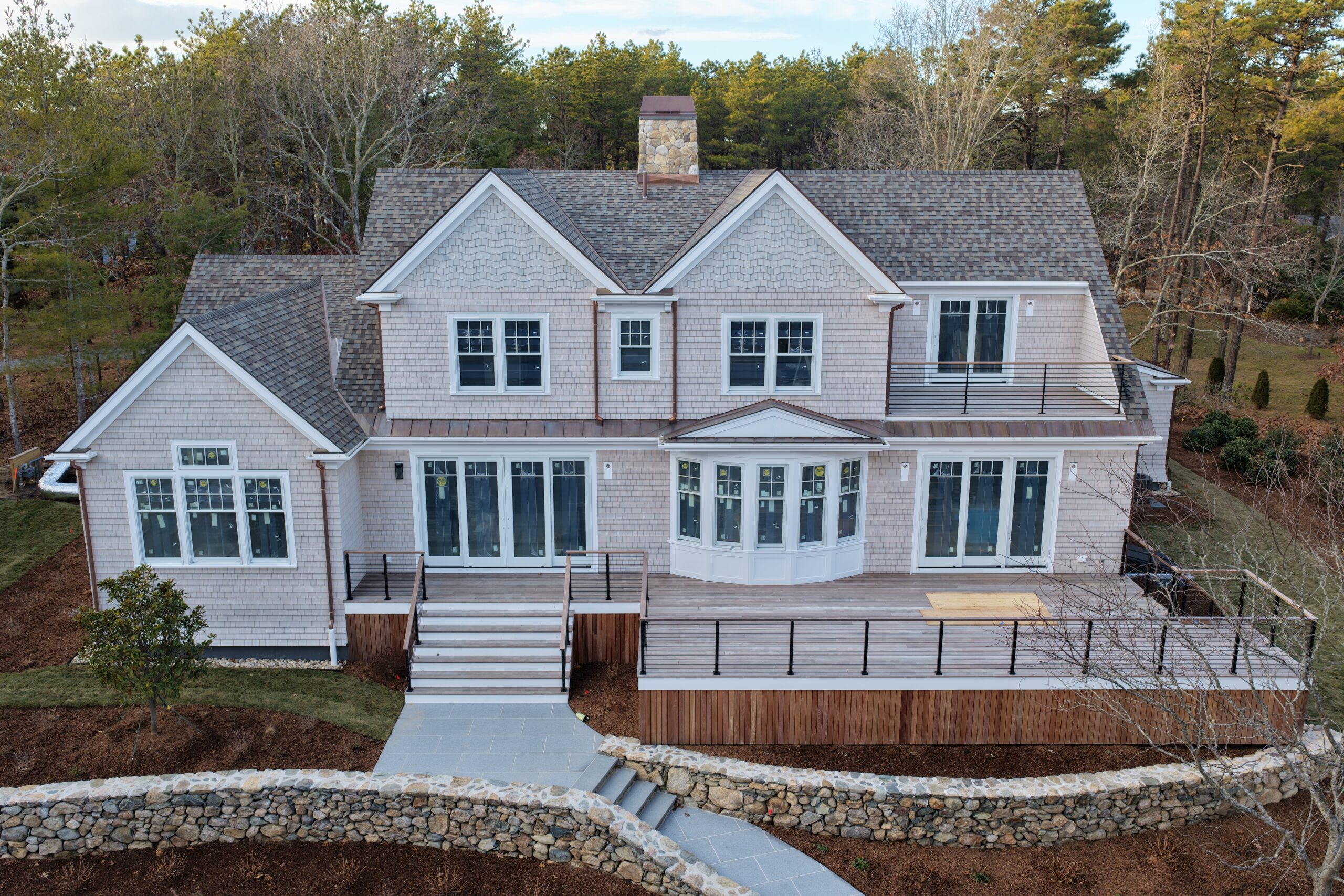 Completed Chatham home exterior with cedar siding, asphalt roof, and copper accents