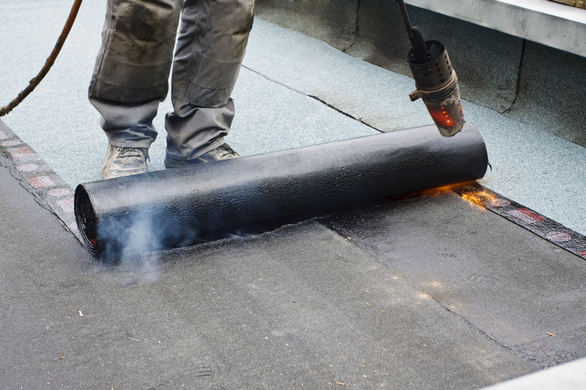 TPO membrane heat welding installation on commercial building Cape Cod