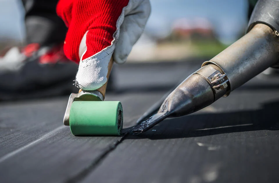 Professional EPDM rubber roofing installation on flat roof