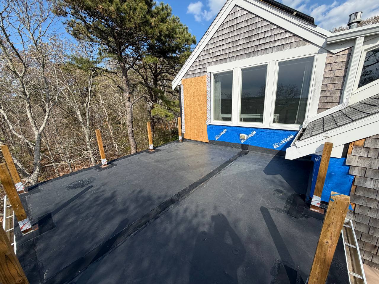 EPDM flat roof replacement Eastham with copper post boots marsh view