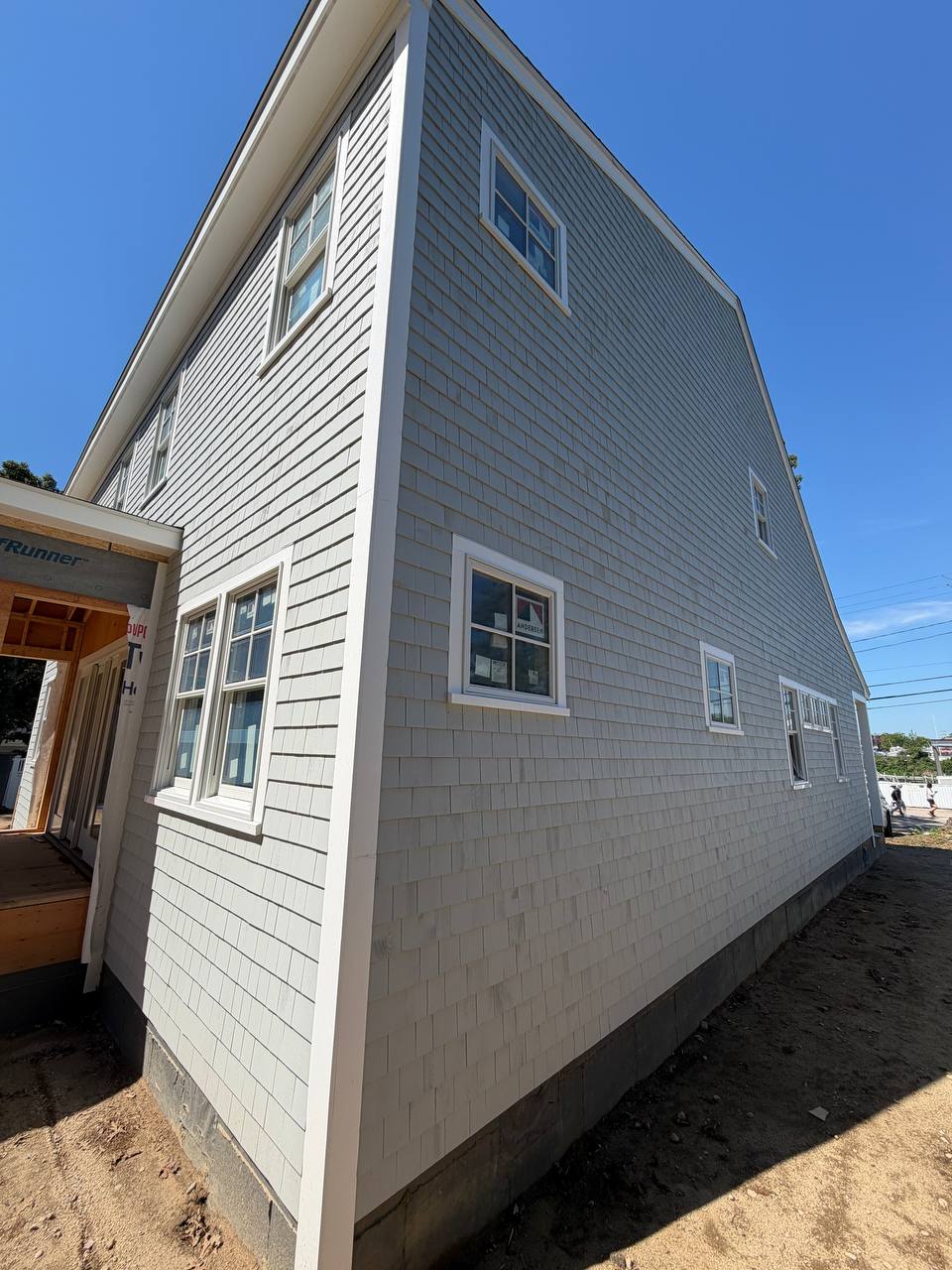 Corner detail of white cedar siding installation