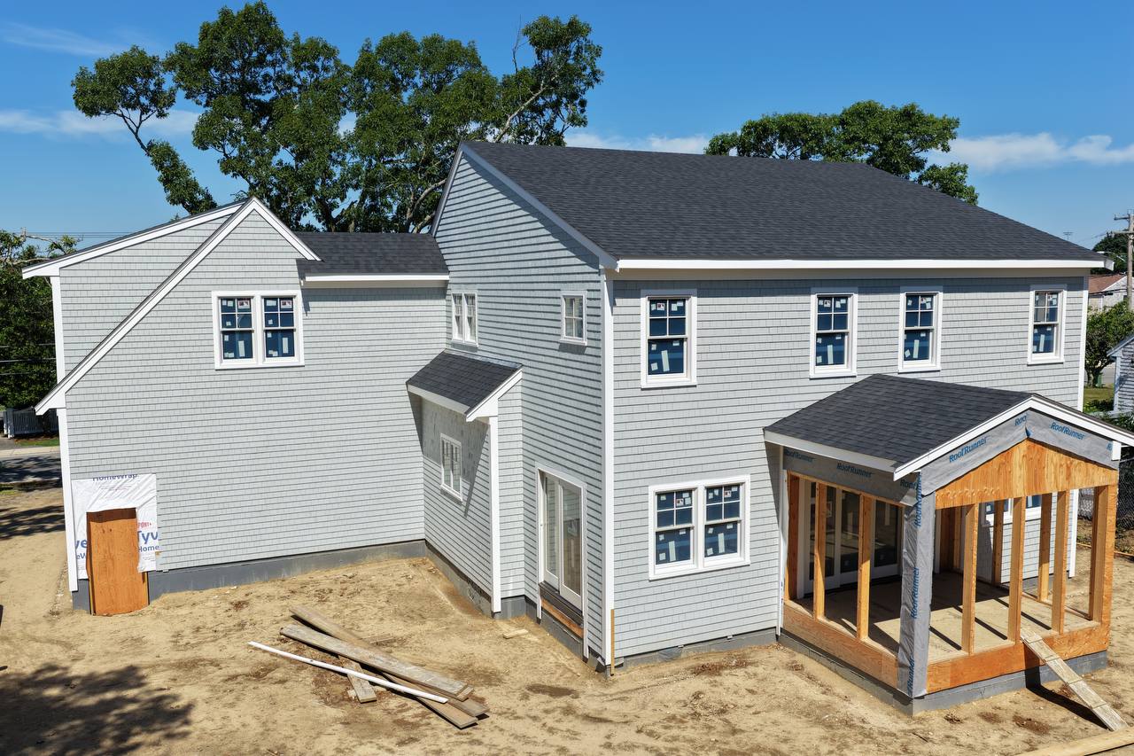 Rear yard view of white cedar siding progress
