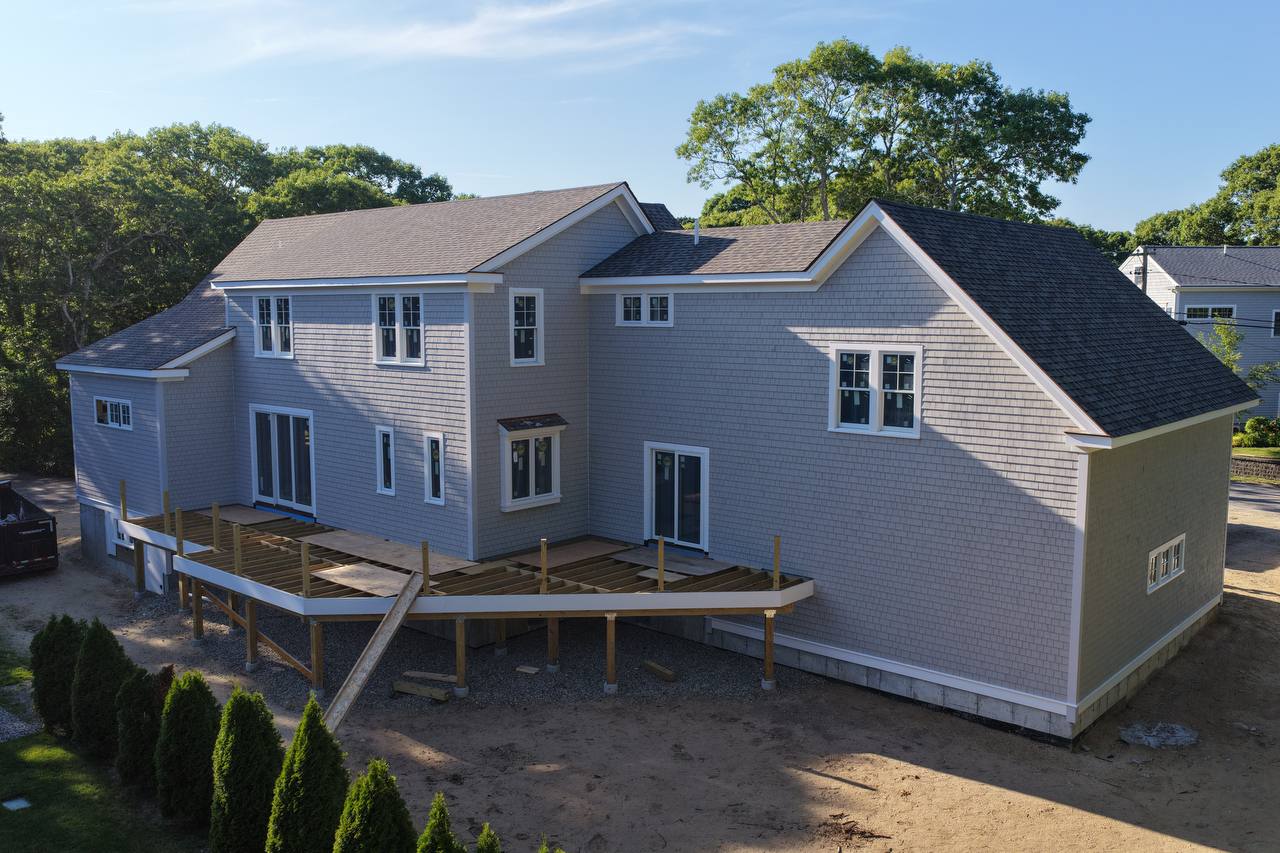 Centerville home with painted white cedar sidewall and new deck framing