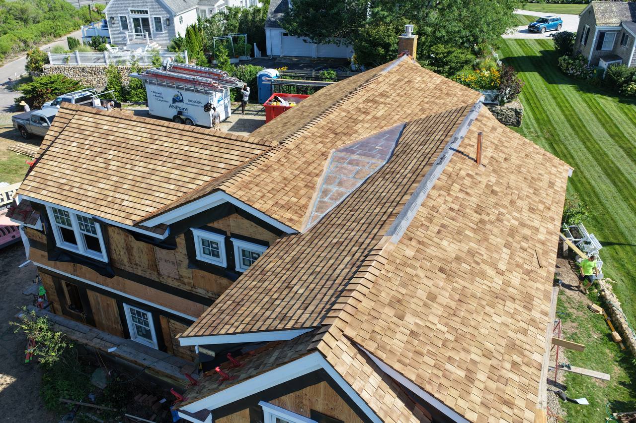 Centerville home with new red cedar roof and red copper roof installation
