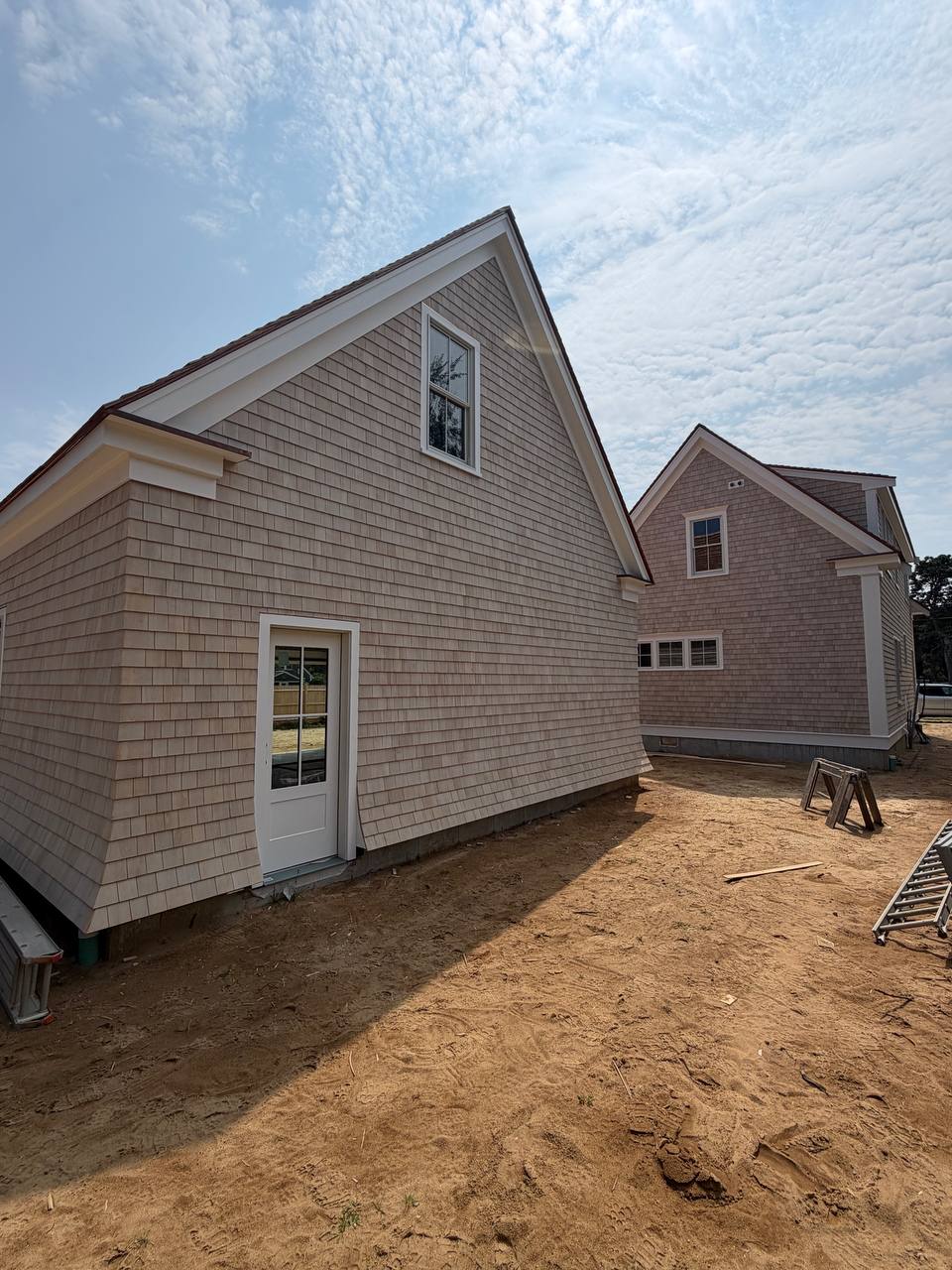 Side view showing cedar shake siding and crisp white trim