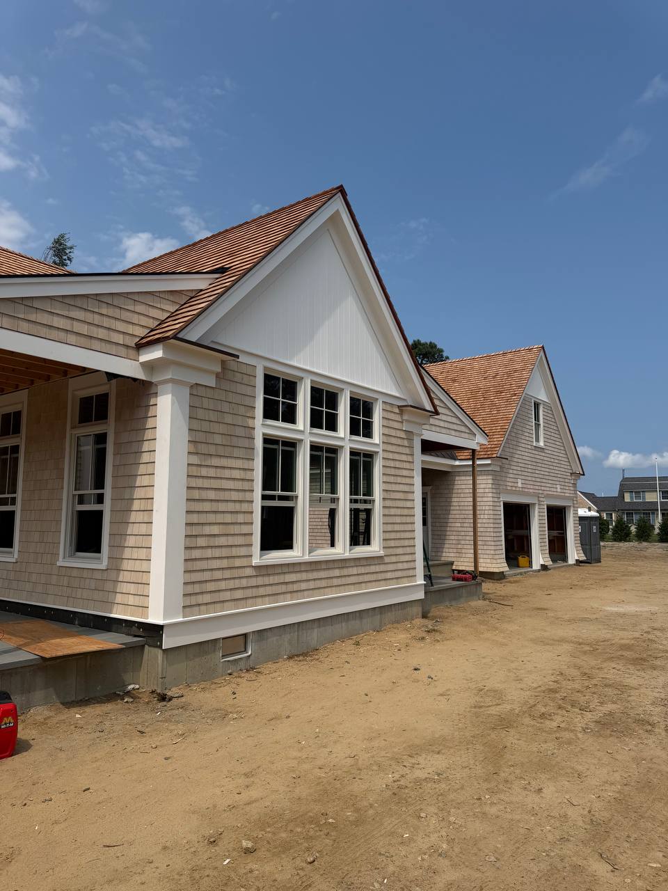 Dennis garage with cedar shake siding, weaved corners, and red cedar roof