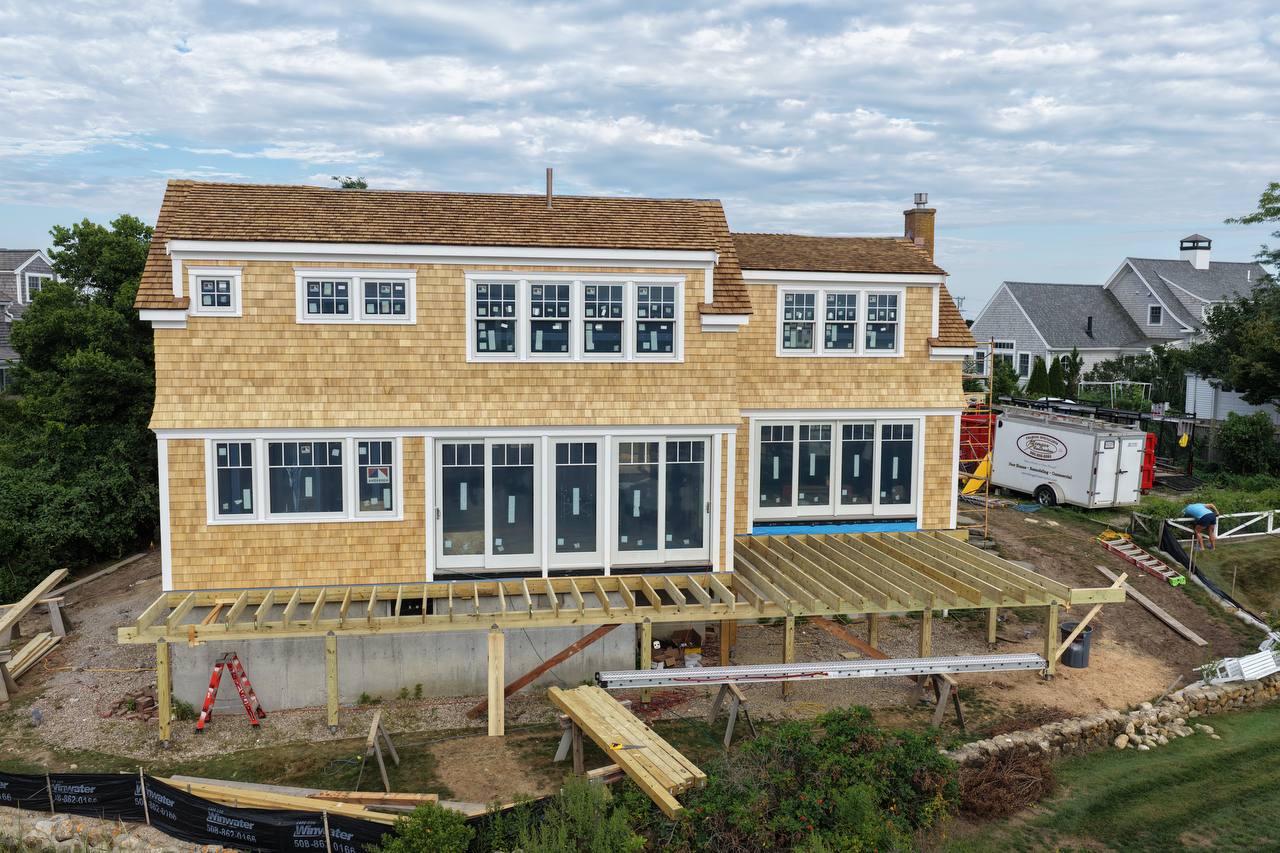 White cedar walls surrounding brick chimney with scaffold