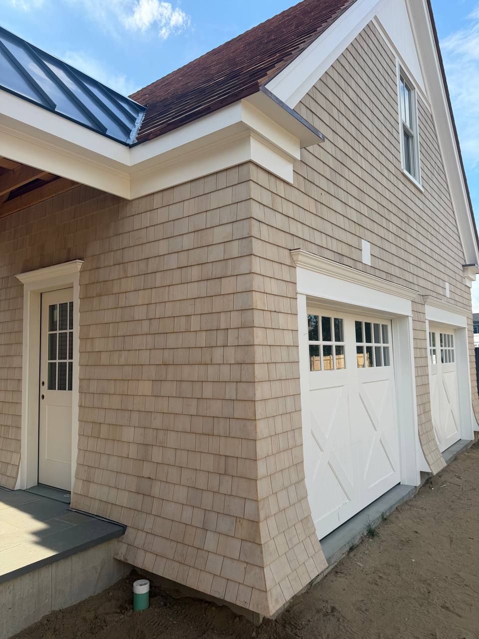 Dennis completed home with standing seam metal roof and red cedar roof