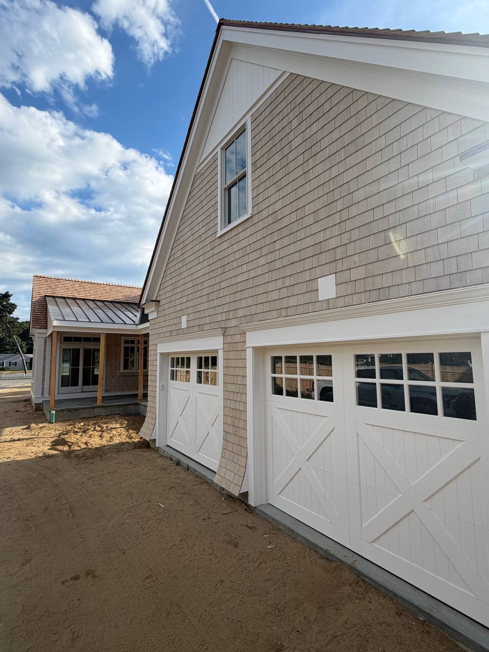Side elevation showing completed roofing and siding work