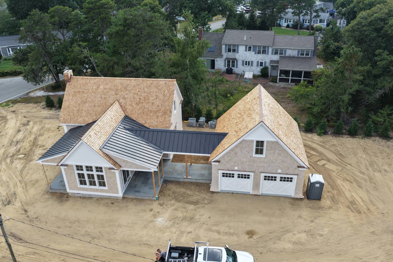 Full view of roof with weaved caps and metal roof